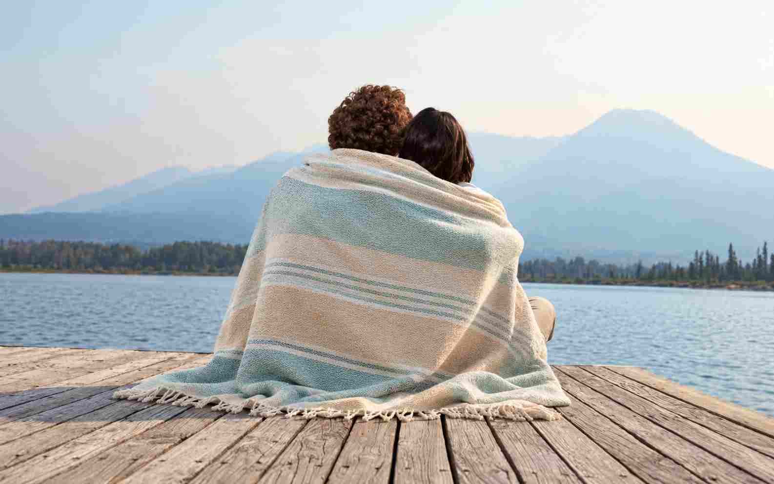 Couple sitting together on a jetty